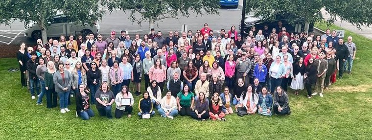 arial image of the Lower Columbia College Faculty and Staff in the grass out front of the LCC Rose Center for the Arts
