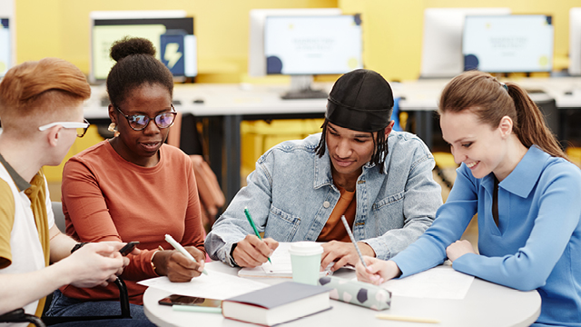 A group of High Shool students studying at a classroom table