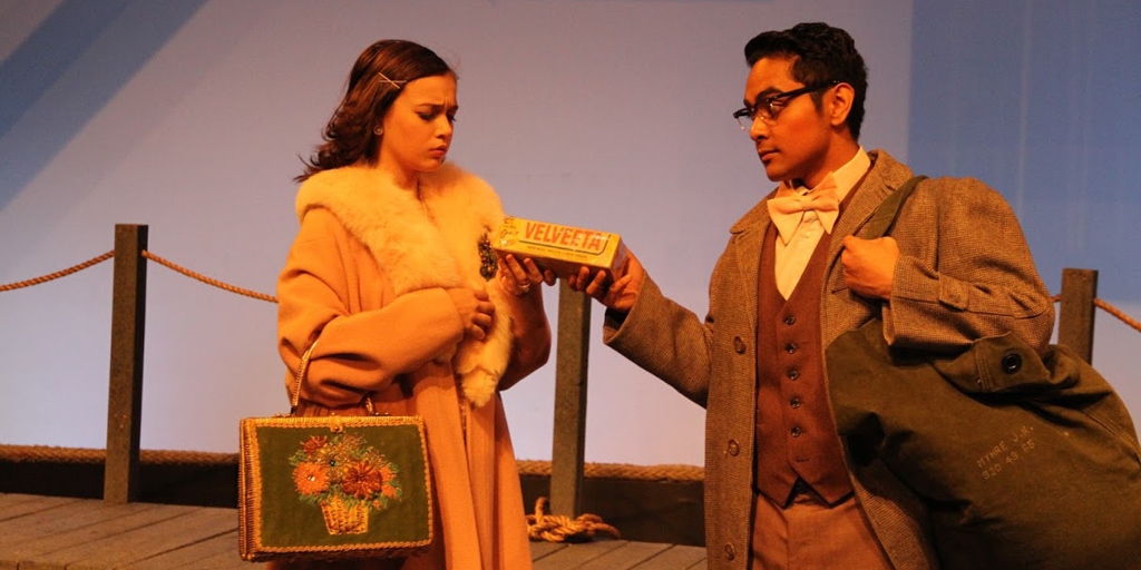 Theatre image man handing woman package