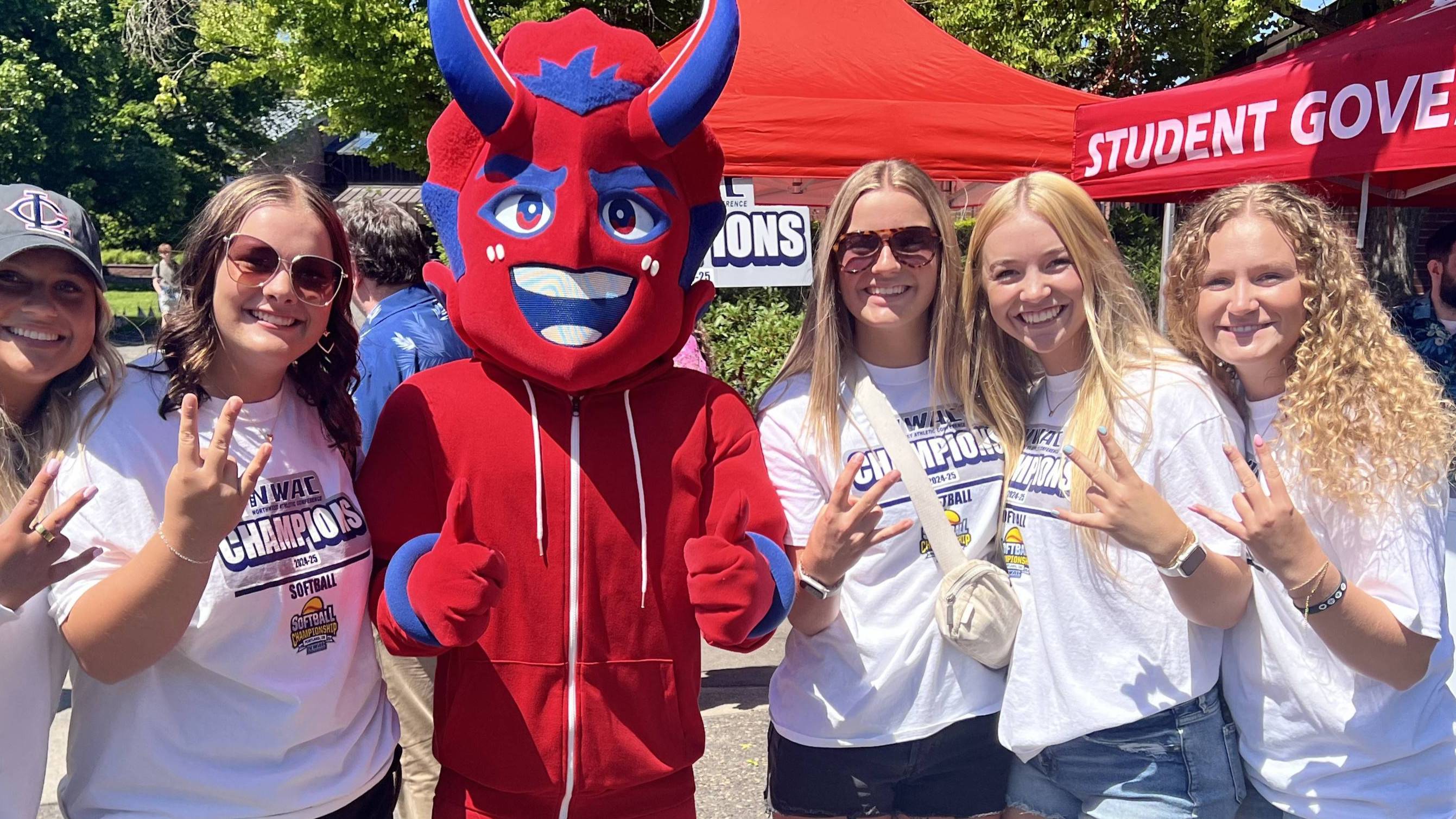 Lower Columbia College Women's Softball team posing with the LCC Flare mascot on a sunny day in the LCC Quad.