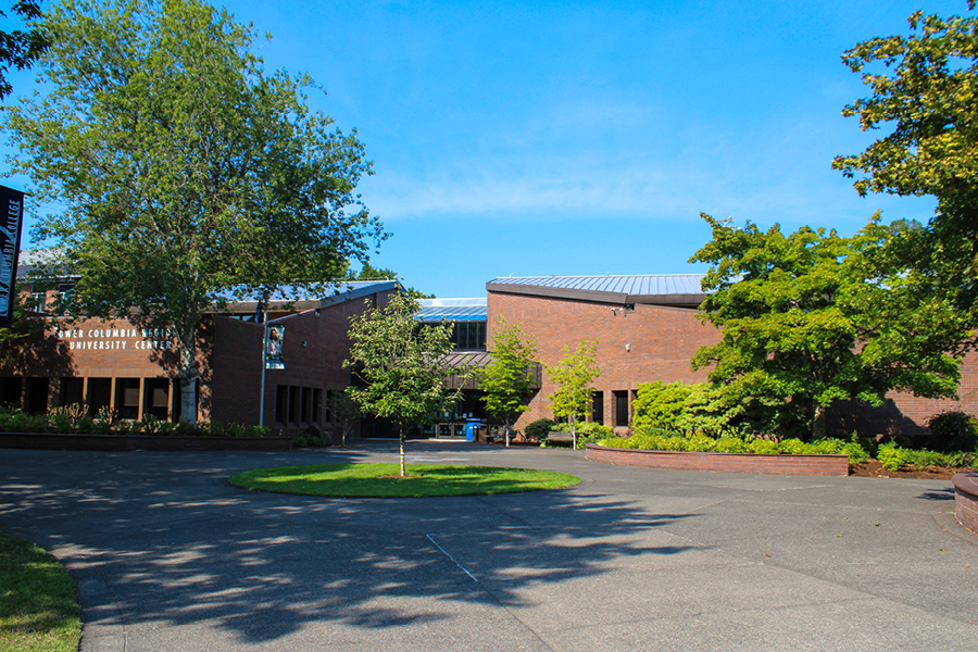 Alan Thompson Library Alan Thompson Library exterior at Lower Columbia College, brick building with trees and courtyard under clear blue sky.